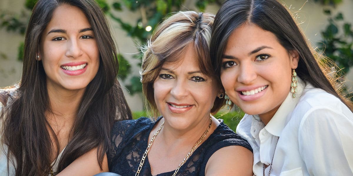 Woman with daughters smiling